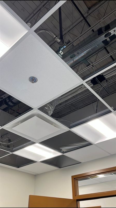 Ceiling grid with sprinkler head and diffuser coordination