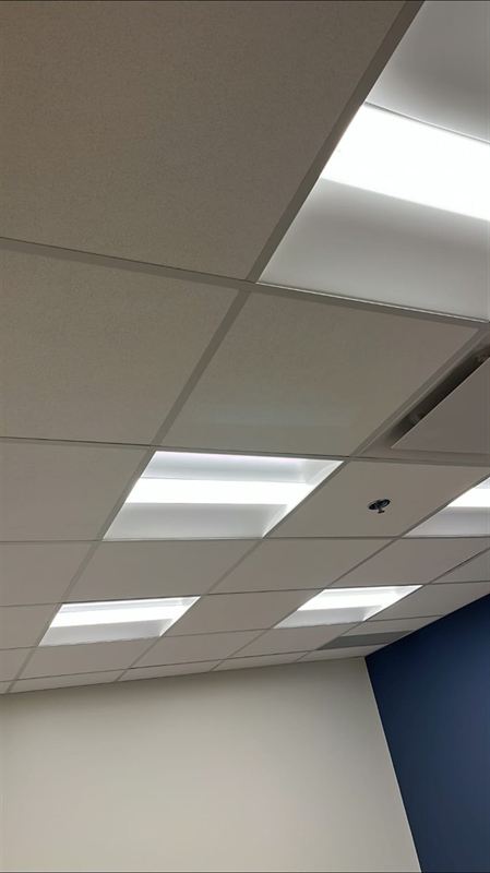 Finished acoustic ceiling with lay-in lighting