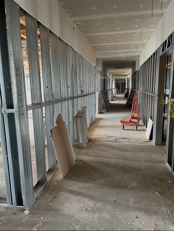 Corridor lined with steel stud demising walls