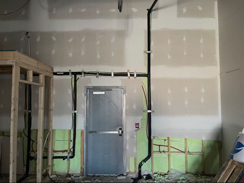 Taped drywall wall with hollow metal door and panic hardware