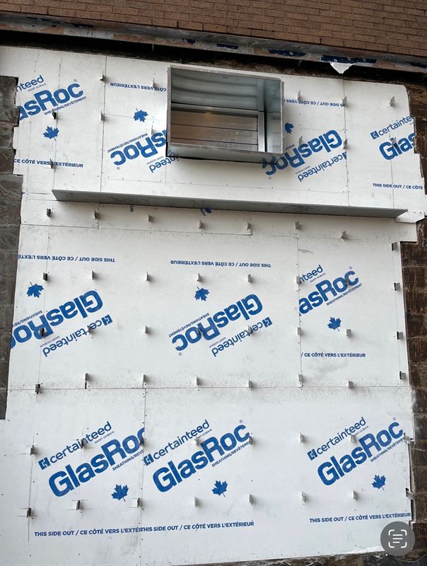 Exterior glass-mat sheathing installed over new framing