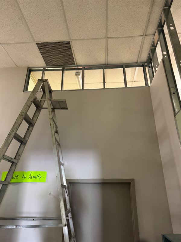 Bulkhead framing above a corridor wall